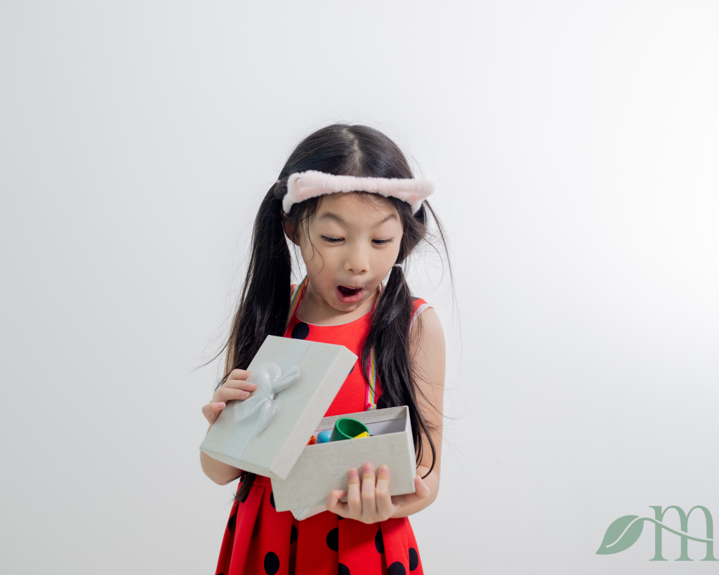 an excited child opening Montessori inspired gifts for preschoolers