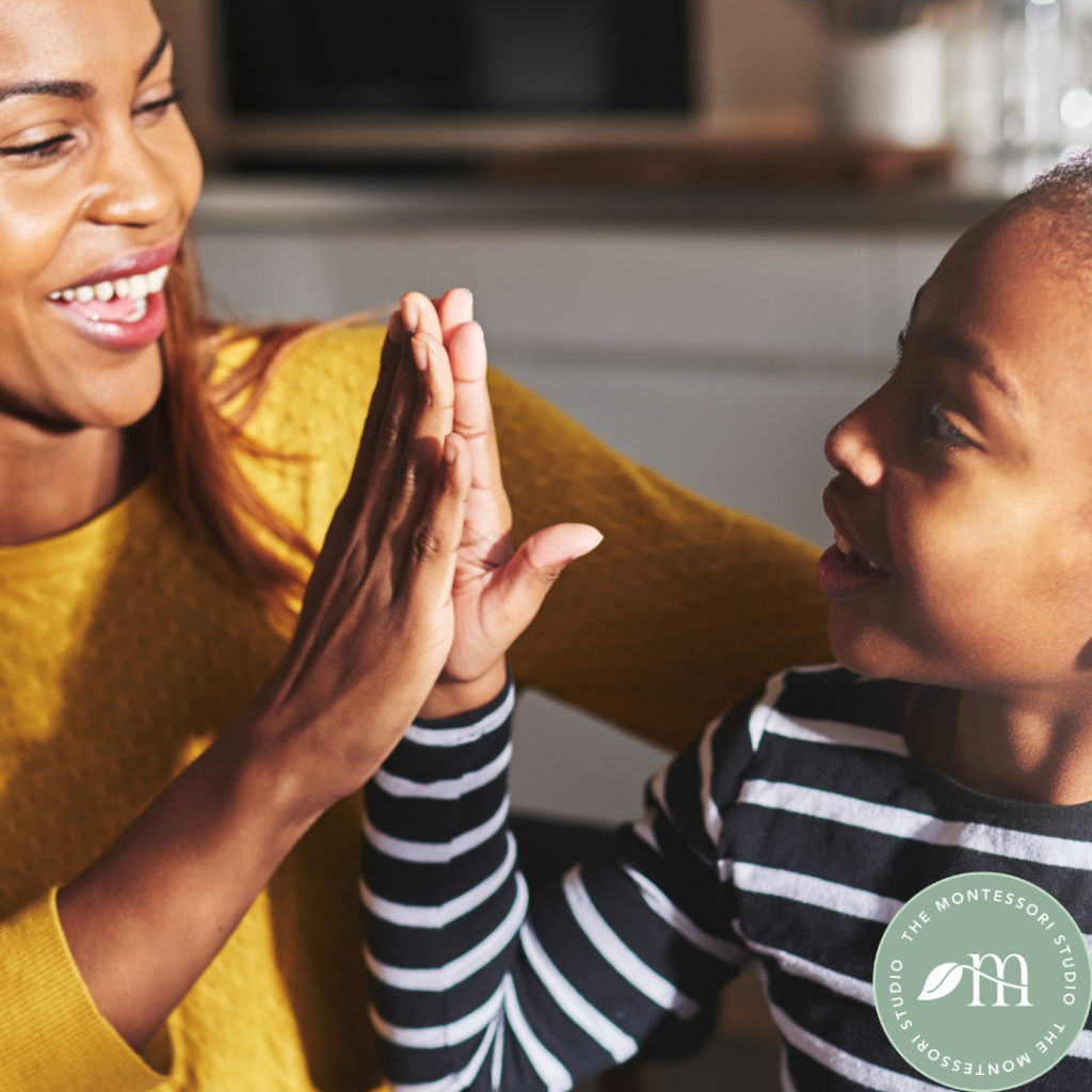 A child and mother exchanging a high five- examples of Montessori alternatives to 'good job'